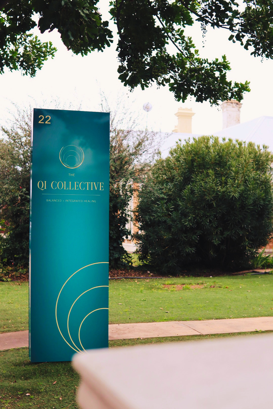 The Qi Collective sign at the front of 22 Kensington Road, Rose Park